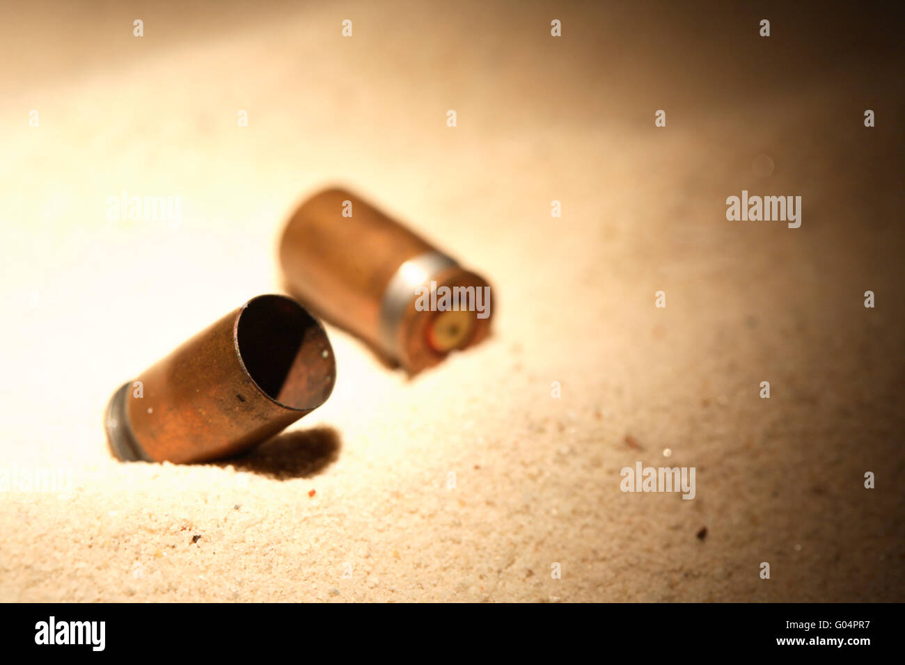 Pistol gun shells on sand background with free space Stock Photo - Alamy