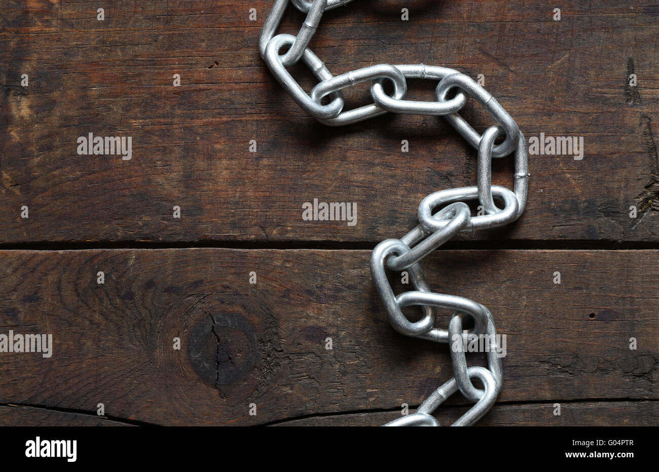 Metal chain on nice old wooden background Stock Photo