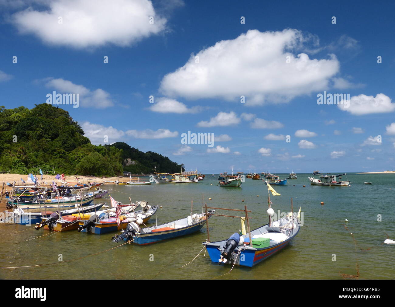 Motor speedboats berthed in a fishing village in the east coast of Malaysia under clear blue skies. Stock Photo