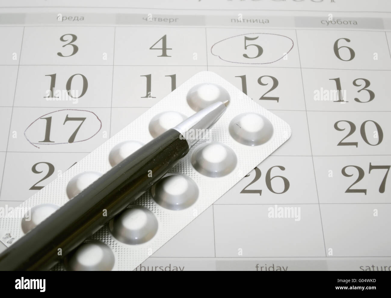 Birth control pills and pen closeup Stock Photo