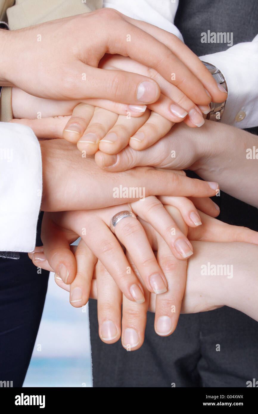 Hands of business people on top of each other Stock Photo - Alamy