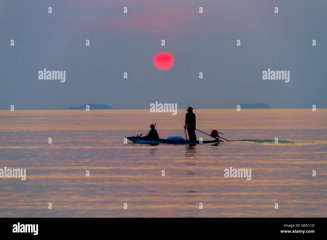The boat with the fishermen at sea on a sunset background Stock Photo ...