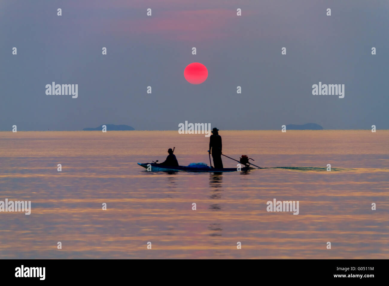 The boat with the fishermen at sea on a sunset background Stock Photo ...