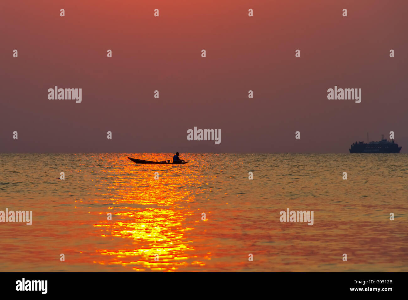 The boat with the fisherman at sea on a sunset background Stock Photo ...