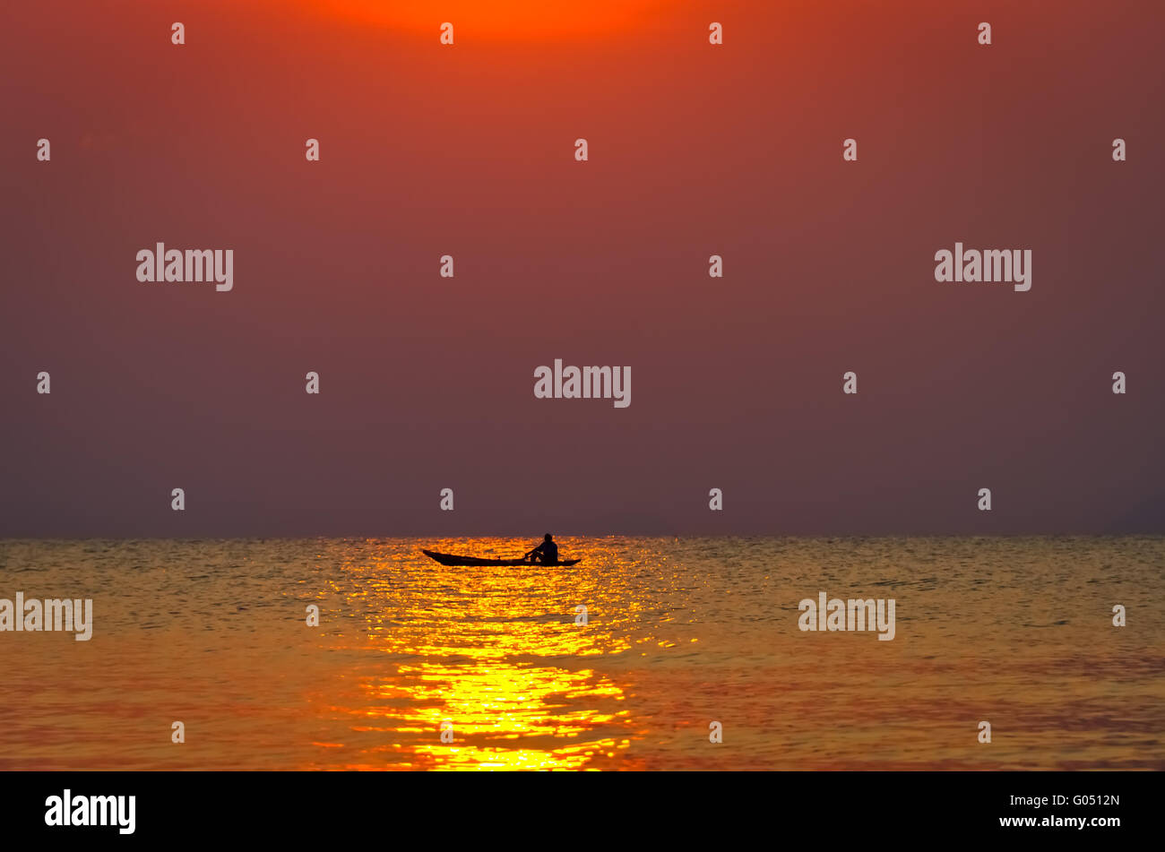 The boat with the fisherman at sea on a sunset background Stock Photo ...