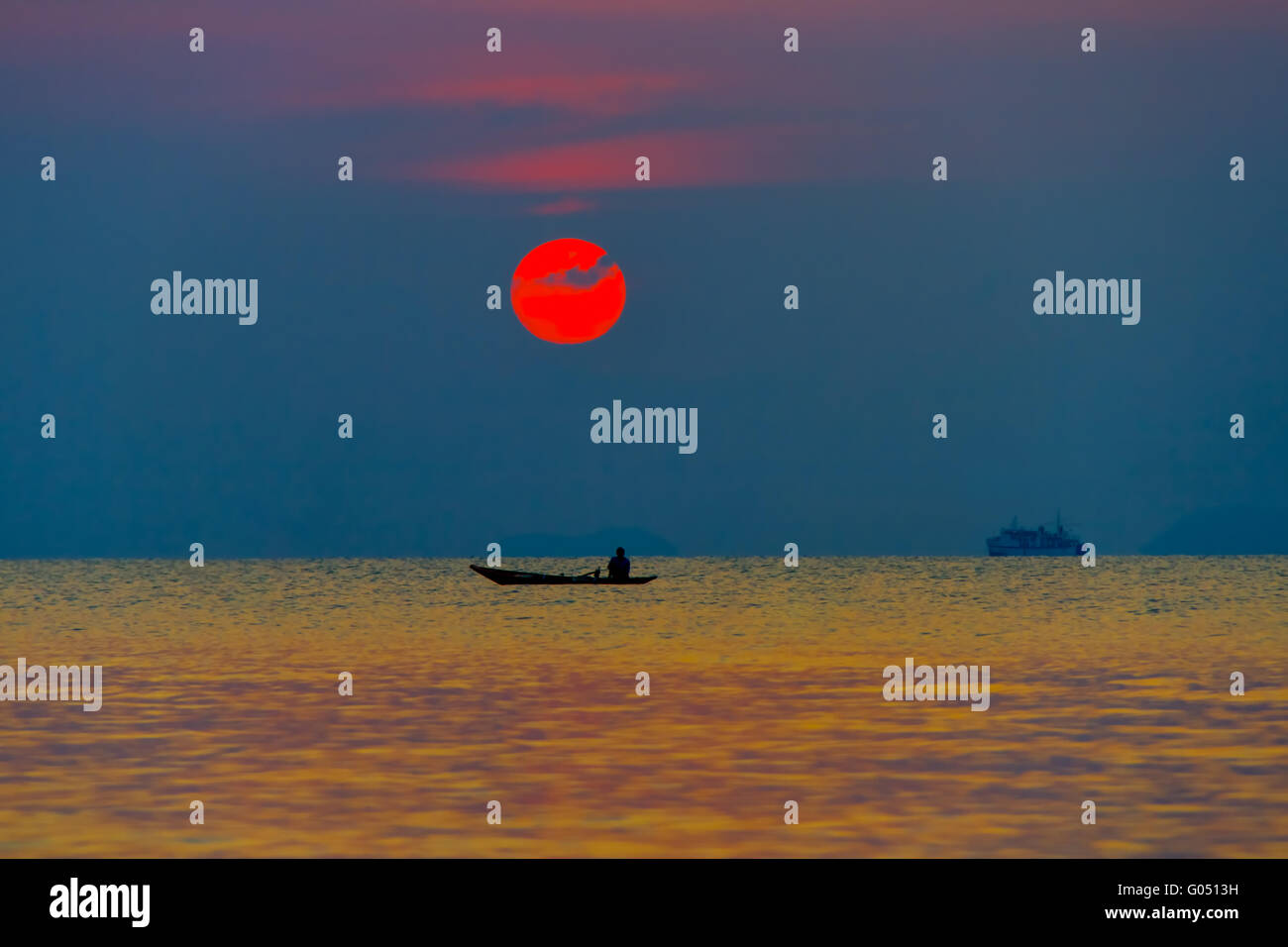 The boat with the fisherman at sea on a sunset background Stock Photo ...