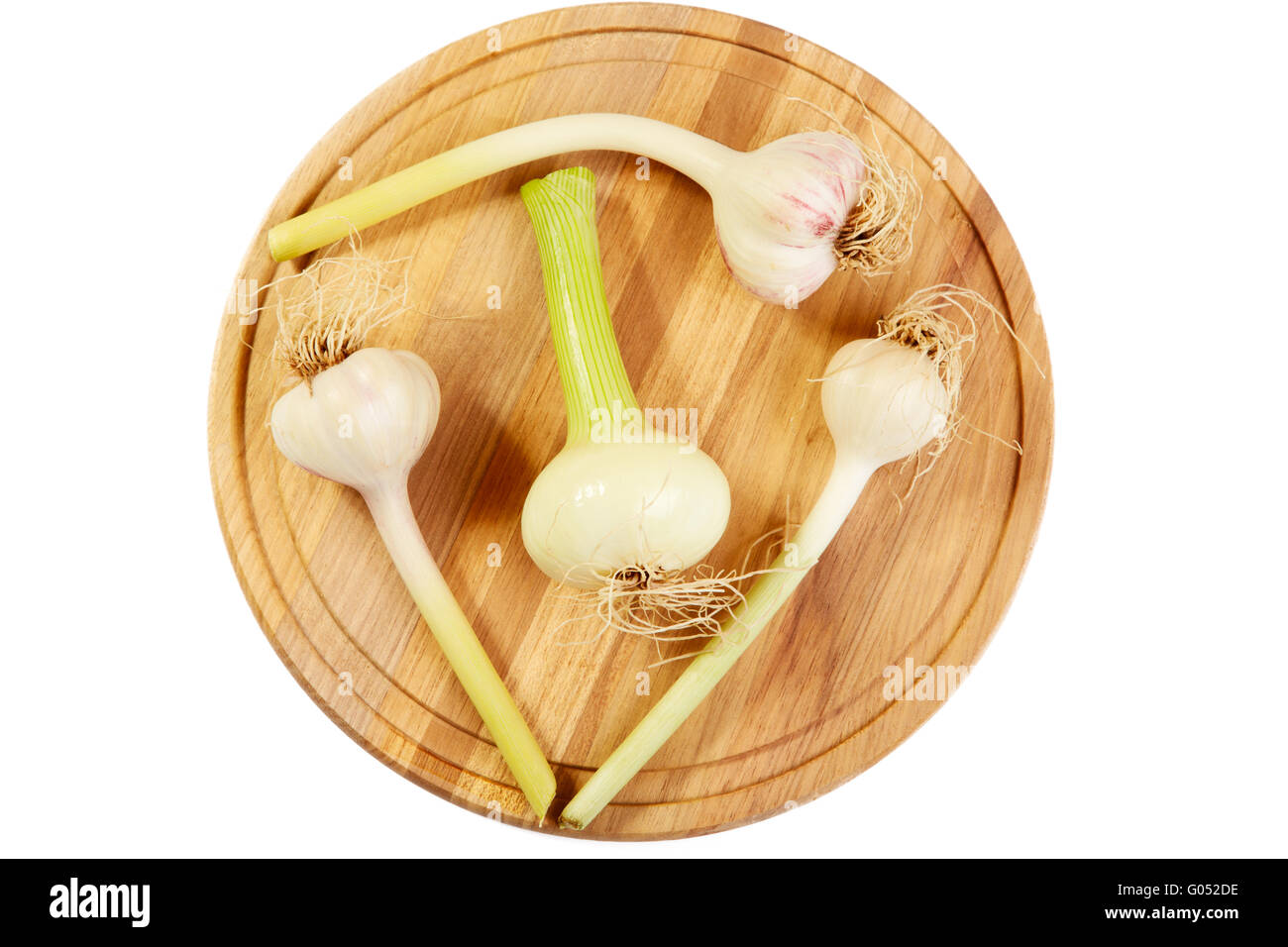 Garlic and onions heads on a chopping board.White background Stock