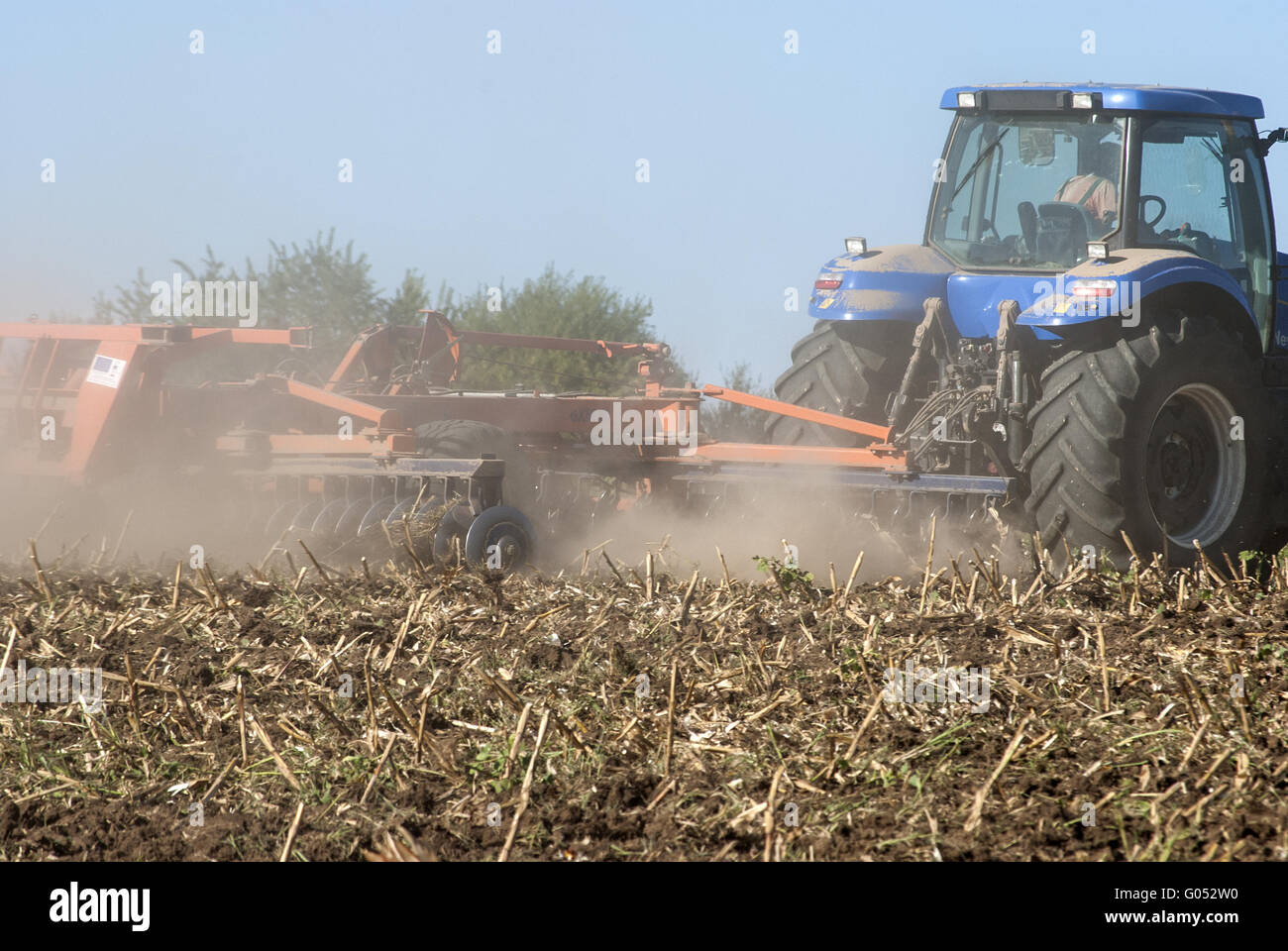 Fall harrowing with tractor on field closeup Stock Photo - Alamy