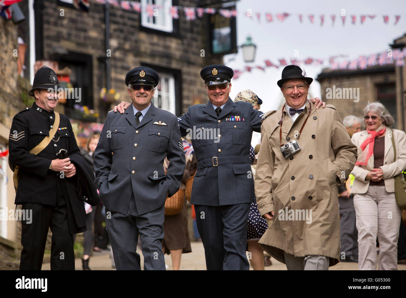 UK, England, Yorkshire, Haworth 40s Weekend, Main Street, men in police, RAF uniform and press costume Stock Photo