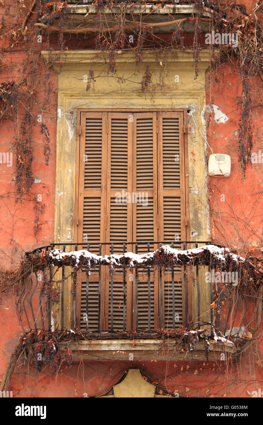 Romantic balcony with closed shutters and metal ba Stock Photo
