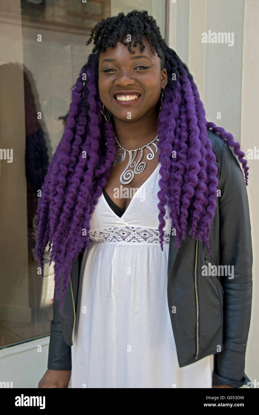 Portrait of a beautiful young lady with long purple hair extensions. In the Soho section of Manhattan, New York City. Stock Photo