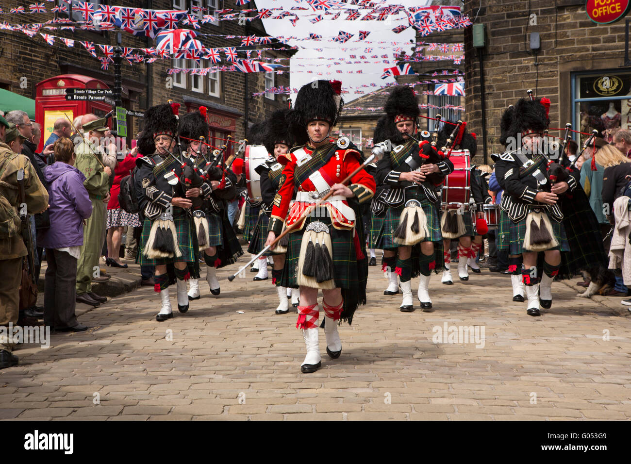 UK, England, Yorkshire, Haworth 40s Weekend, City of Bradford Pipe Band marching through village Stock Photo