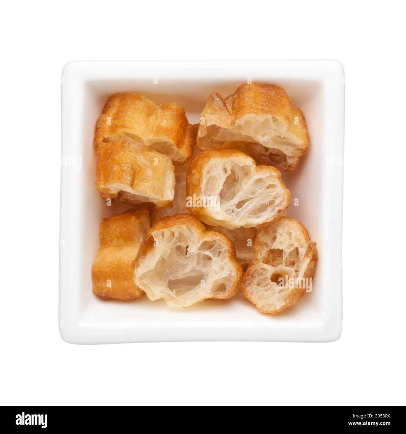 Sliced Chinese fried dough in a square bowl isolated on white background Stock Photo