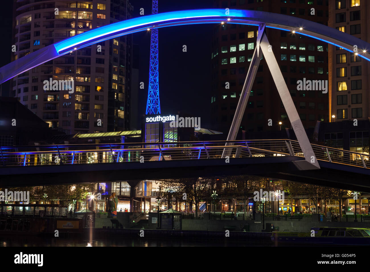 Melbourne CBD - APR 16 2016: Southbank footbridge and Melbourne Arts Centre tower closeup at night. Stock Photo