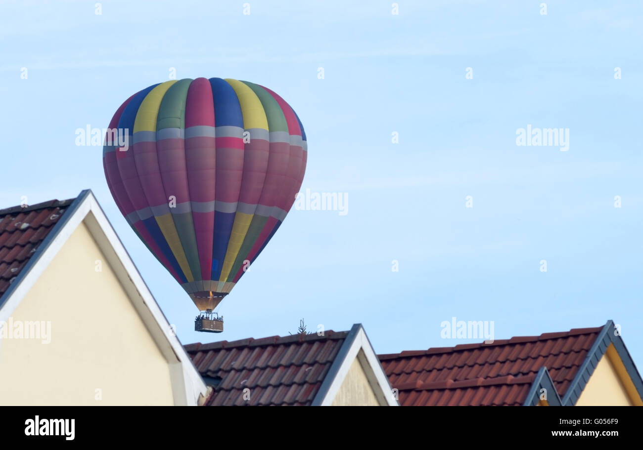 hot air ballon close over roofs 2 Stock Photo