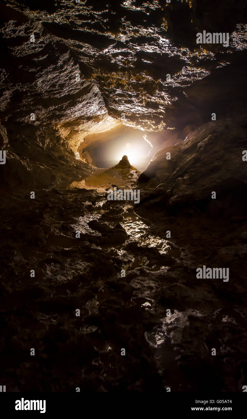 light at the entrance of a dark cave Stock Photo