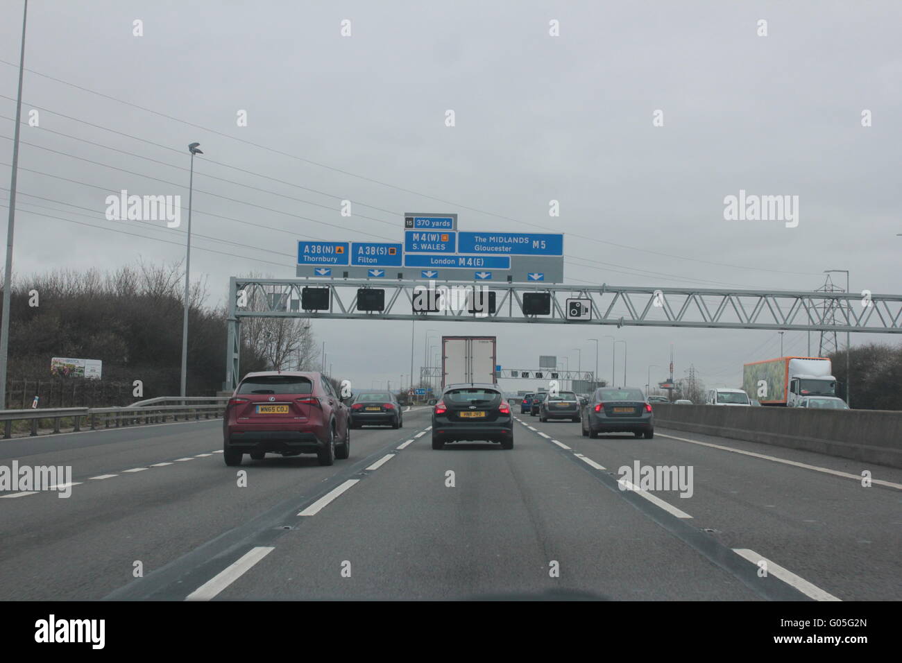 Traffic on the motorway with blue signs Stock Photo Alamy