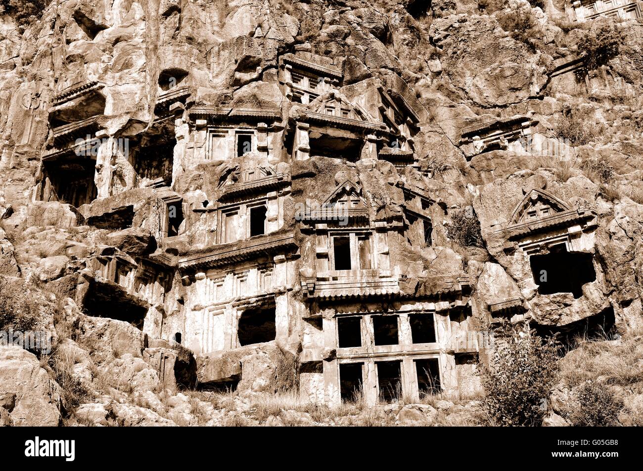 Ruins of the rock tombs in Myra Turkey sepia Stock Photo