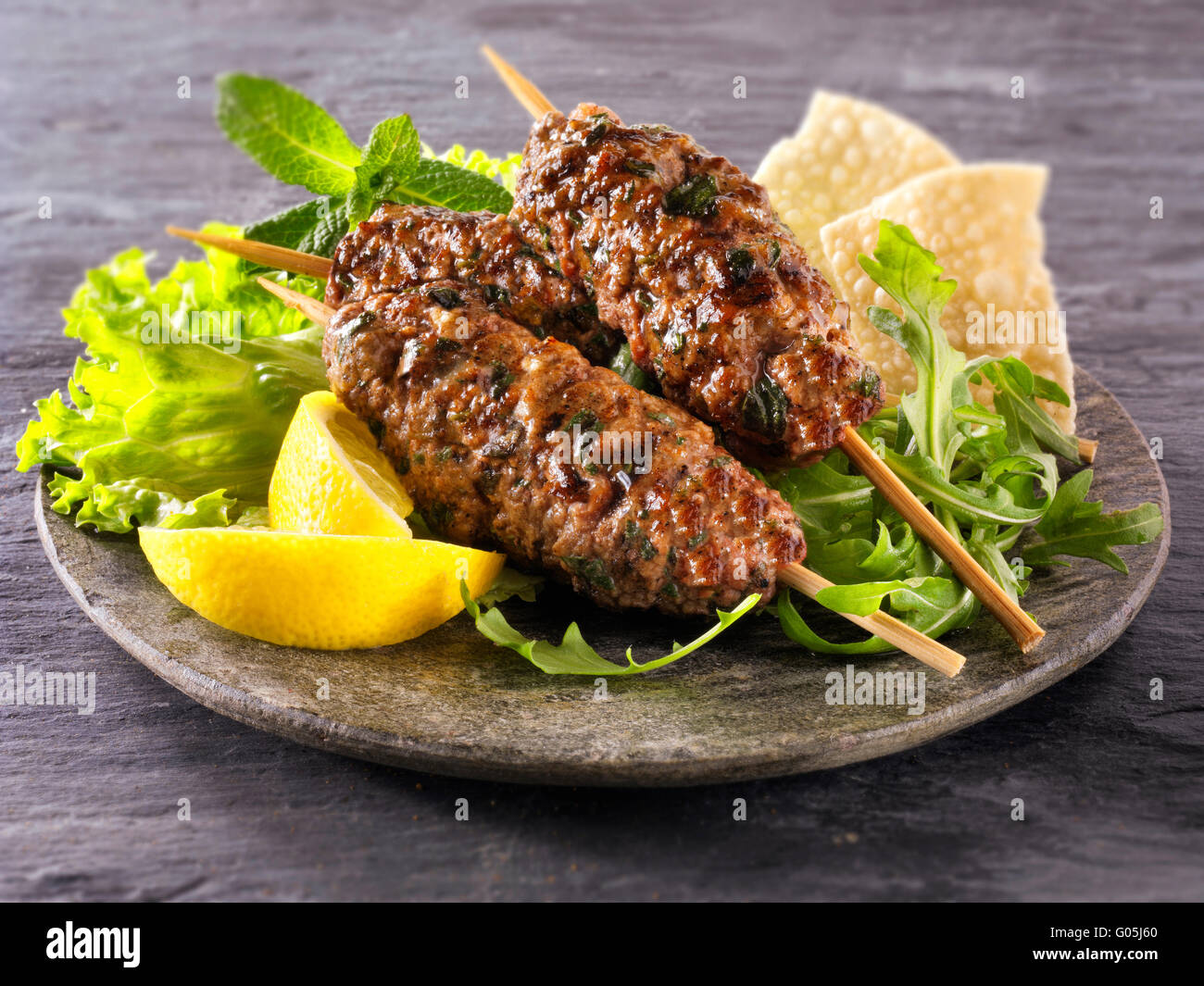 Kofte Kebab with salad & lemon wedges Stock Photo