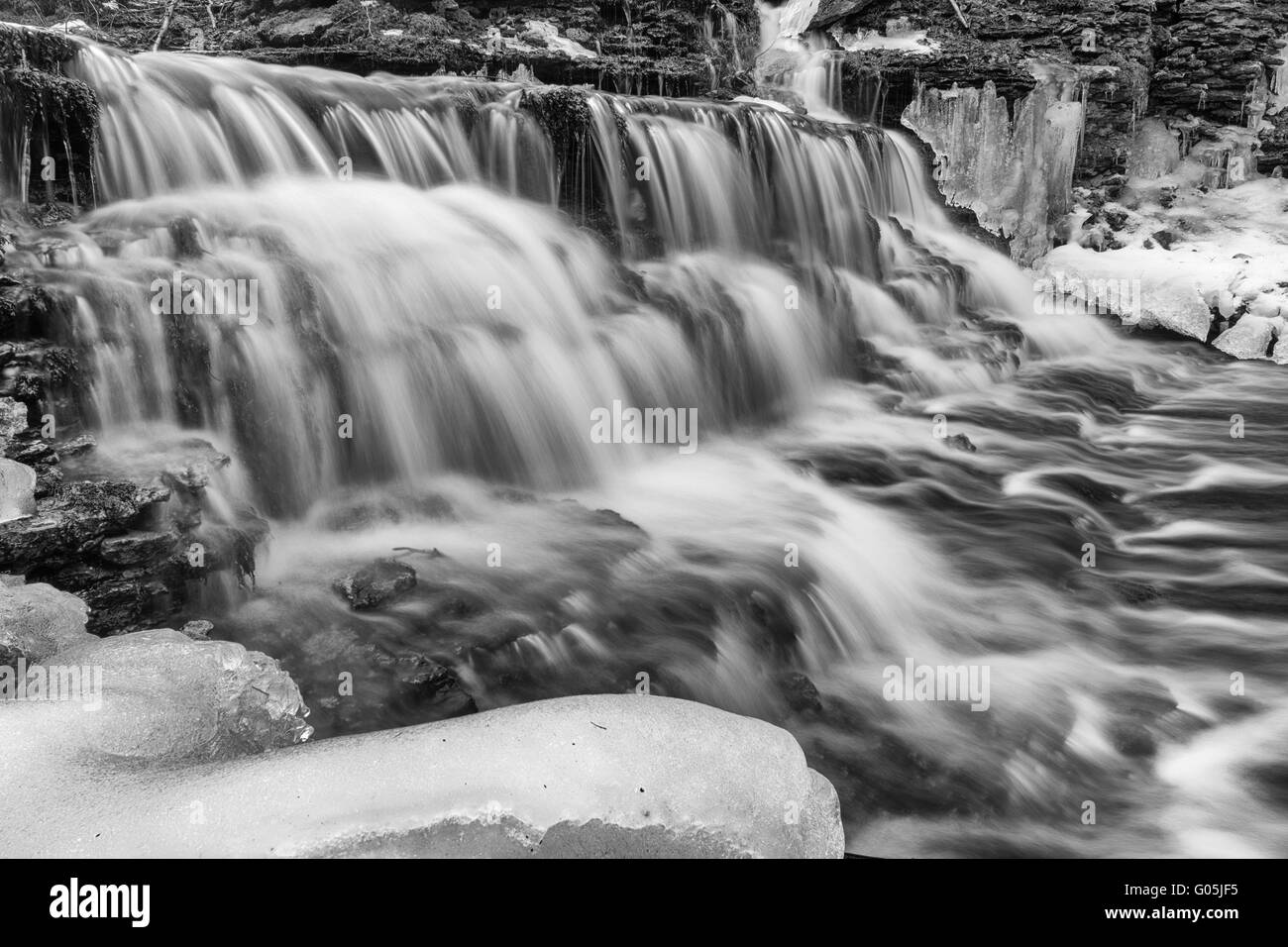 Vasaristi cascade by early spring in Lahemaa national park, Estonia. Long exposure, monochrome image Stock Photo