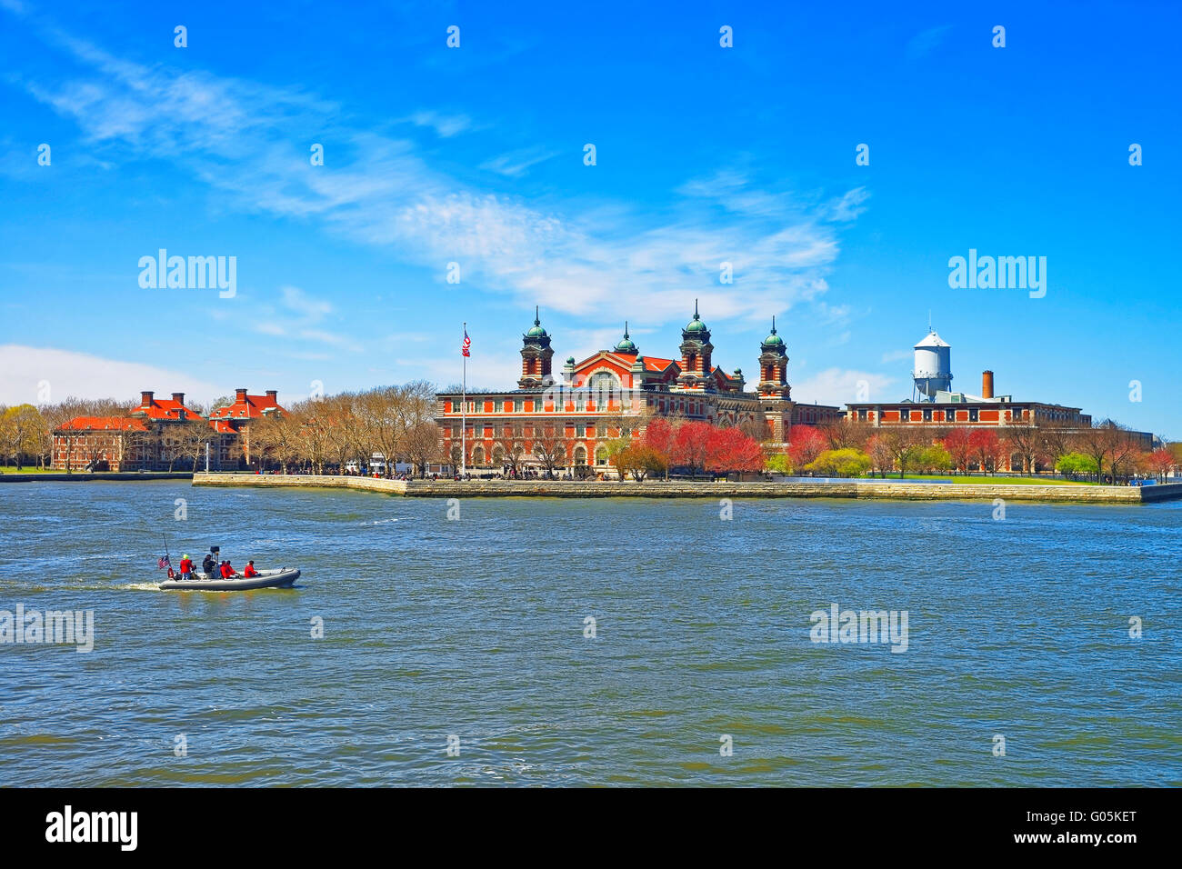 Immigration station in Ellis Island, USA, and boat in Upper New York Bay. It was a gateway for immigrants who came to immigrant Stock Photo