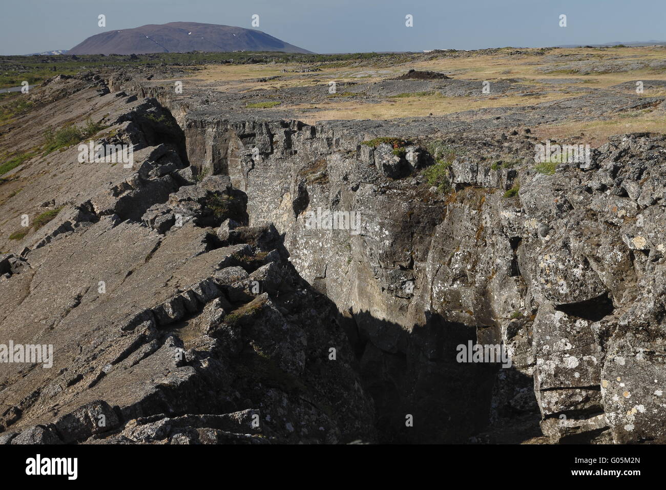 Tectonic crack near Grjótagjá and the Sellandafjall tuya volcanic mountain. Mývatn region Stock Photo