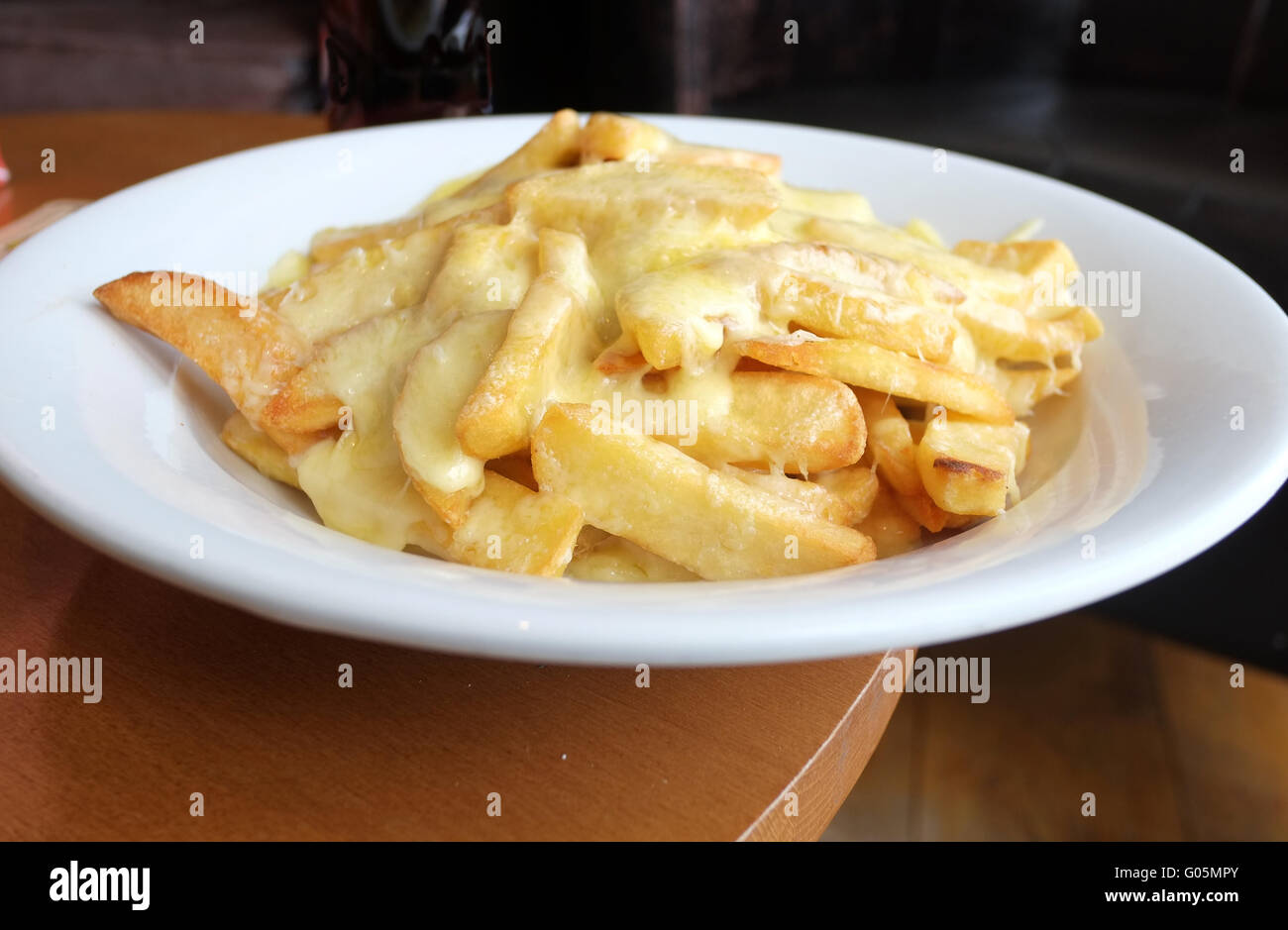 A plateful of cheesy chips in a bar in Brean, Somerset, England, UK