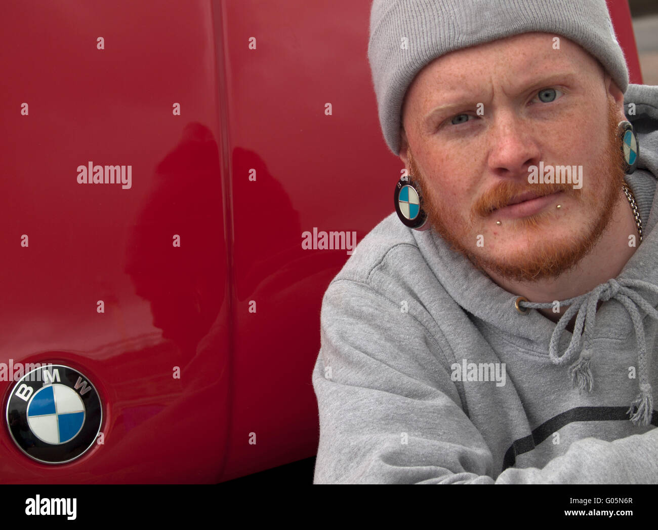 A car lover wearing BMW themed earrings Stock Photo