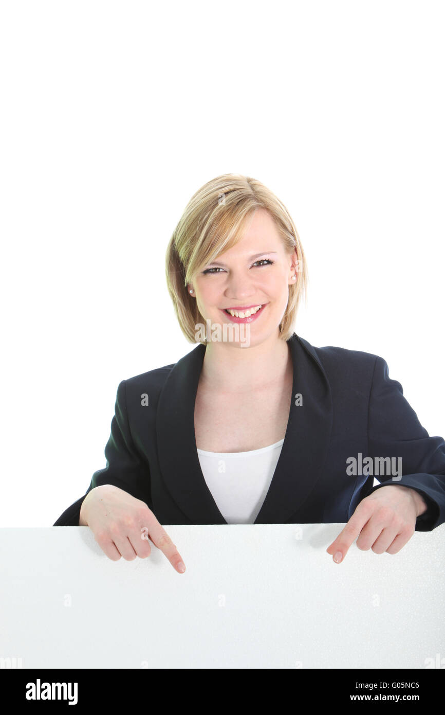 Smiling business woman pointing on white board Stock Photo
