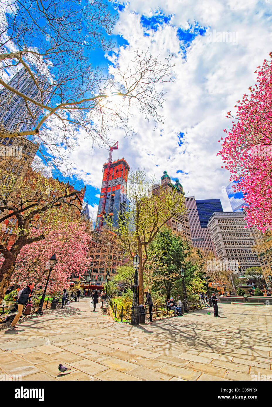 New York, USA - April 24, 2015: City Hall Park with tourists, Lower Manhattan, New York, USA. Skyscrapers on the background. Stock Photo
