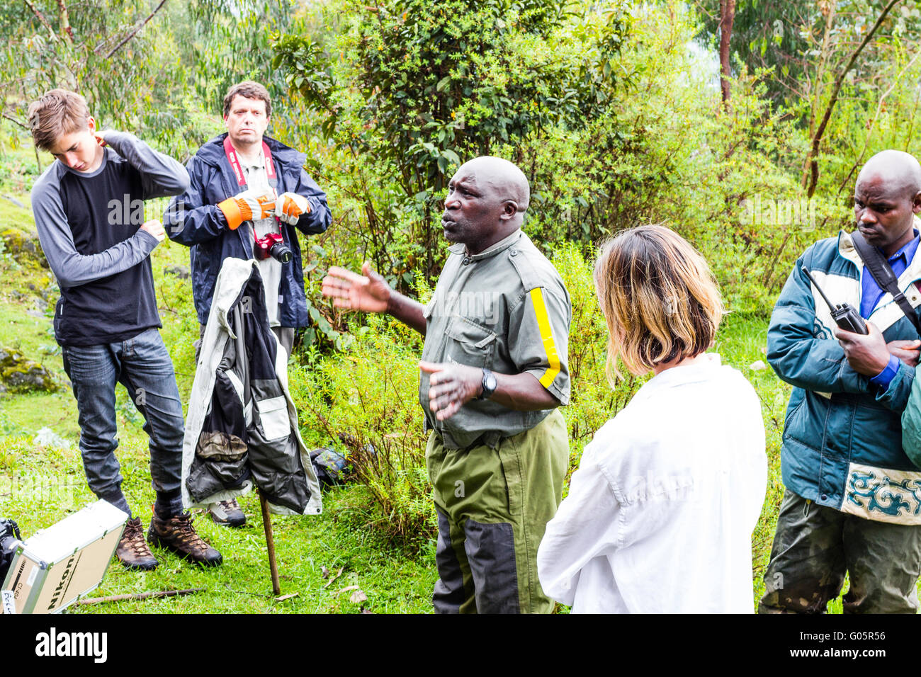 Volcanoes National Park, Rwanda. Tourists and photographers receive a briefing from guide François Bigirimana. Stock Photo