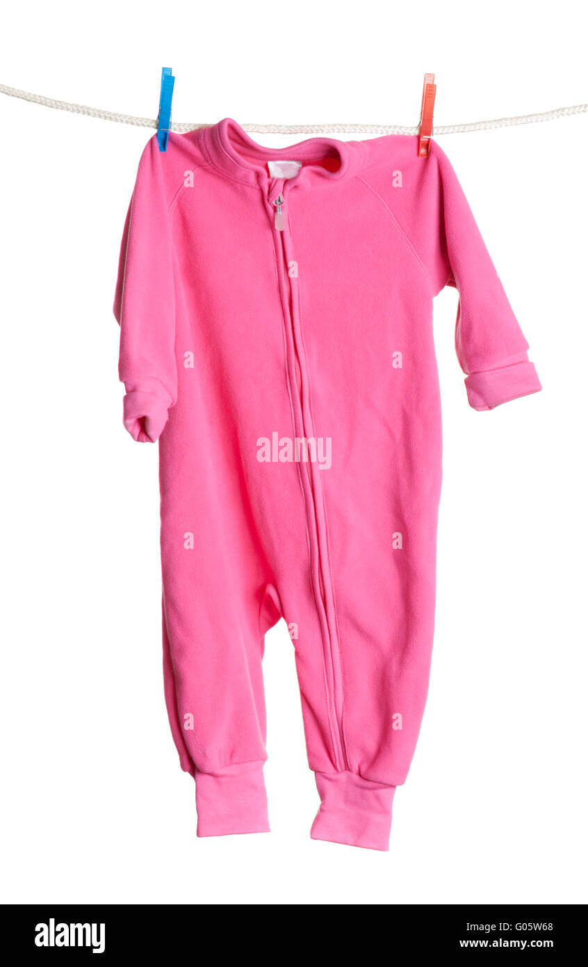 Children's overalls hanging on a clothesline on white background Stock