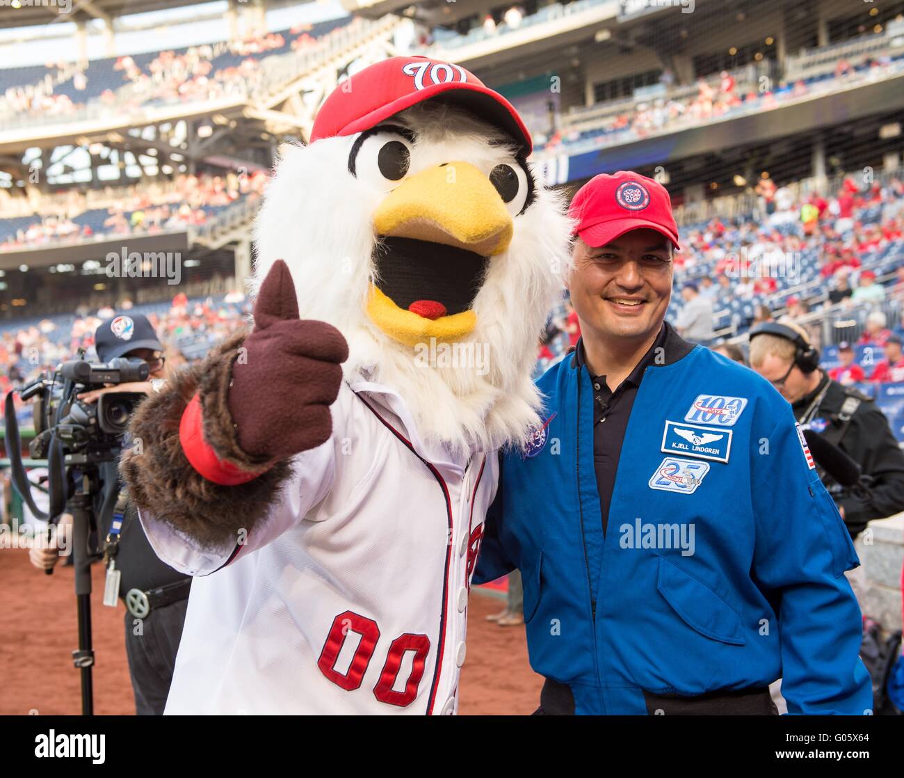 NASA astronaut Kjell Lindgren poses for a photo with the Washington Nationals mascot prior to throwing the ceremonial first pitch before the Washington Nationals take on the Philadelphia Phillies at Nationals Park April 26, 2016 in Washington, DC. Lindgren spent 141 days aboard the International Space Station as part of Expeditions 44 and 45. Stock Photo