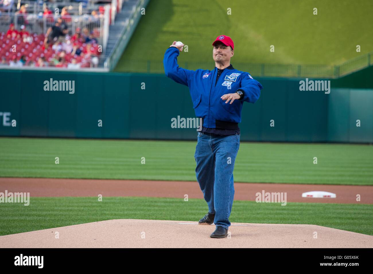 NASA astronaut Kjell Lindgren throws out the ceremonial first pitch before the Washington Nationals take on the Philadelphia Phillies at Nationals Park April 26, 2016 in Washington, DC. Lindgren spent 141 days aboard the International Space Station as part of Expeditions 44 and 45. Stock Photo