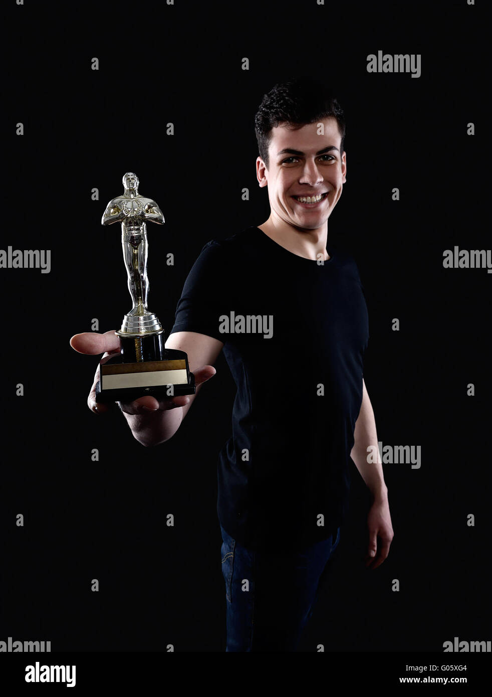 young man holding fake oscar award Stock Photo