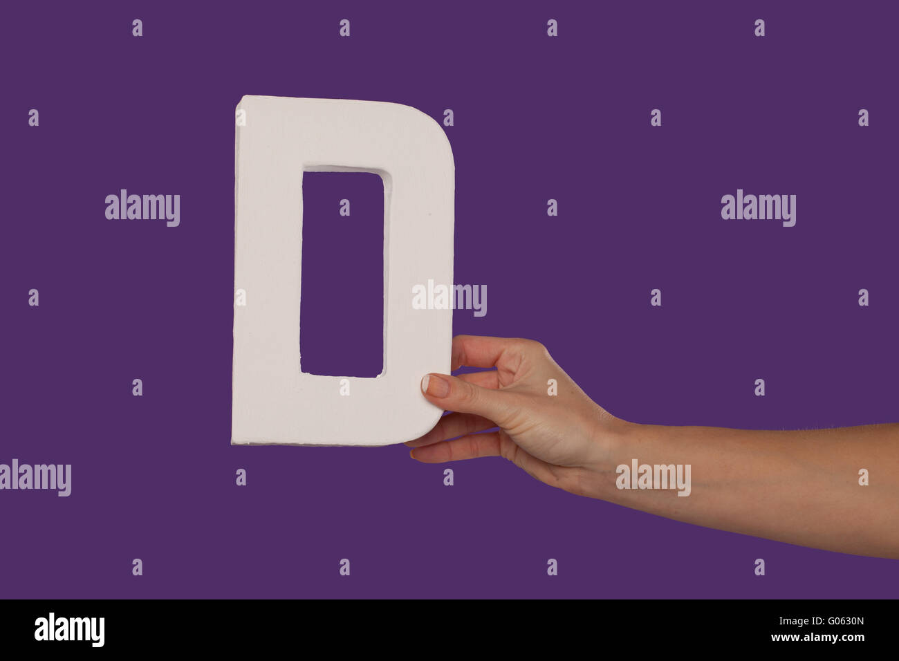 Female hand holding up the letter D from the right Stock Photo - Alamy