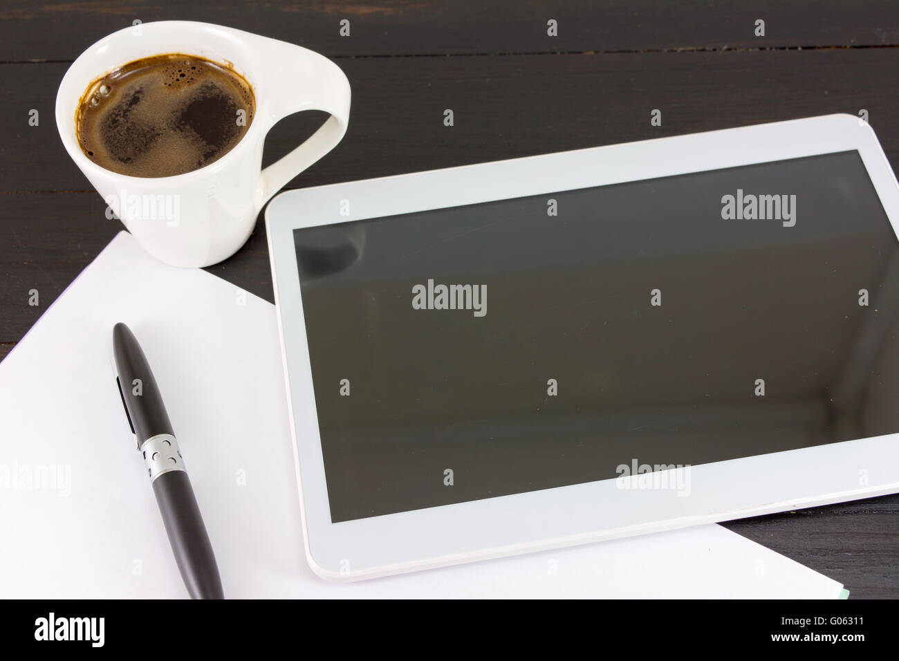 Cup of coffe for a good working day. Coffee and tech accessories on black table Stock Photo