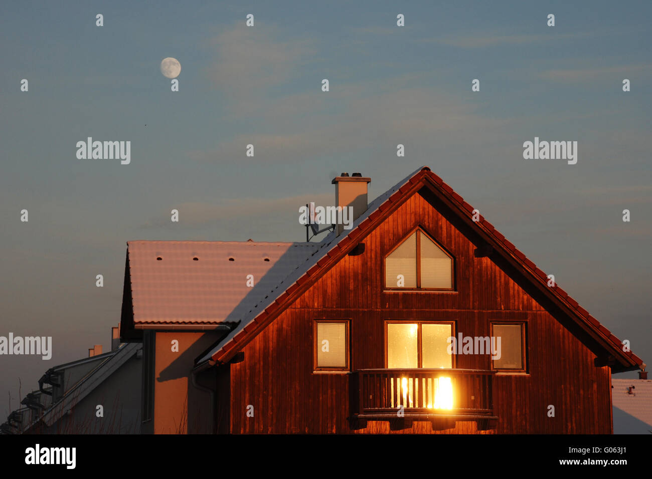 Wintersun reflecting in the window of a house Stock Photo