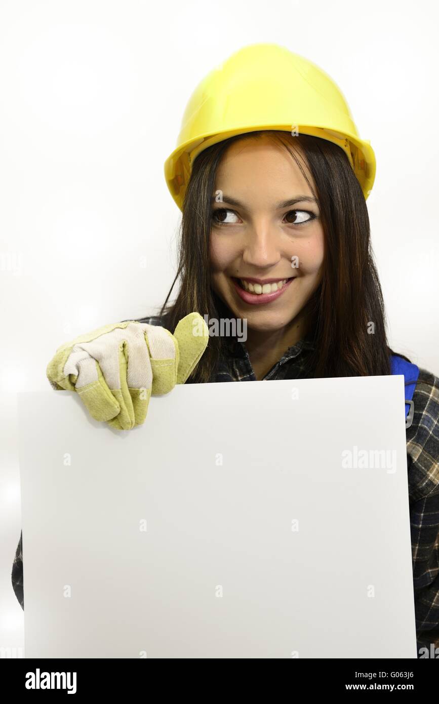 brunette young woman with work clothes and hard ha Stock Photo