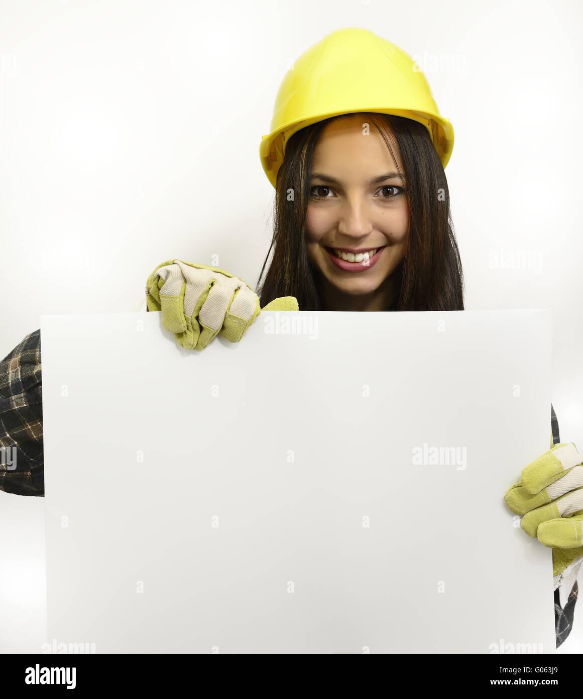 brunette young woman with work clothes and hard ha Stock Photo