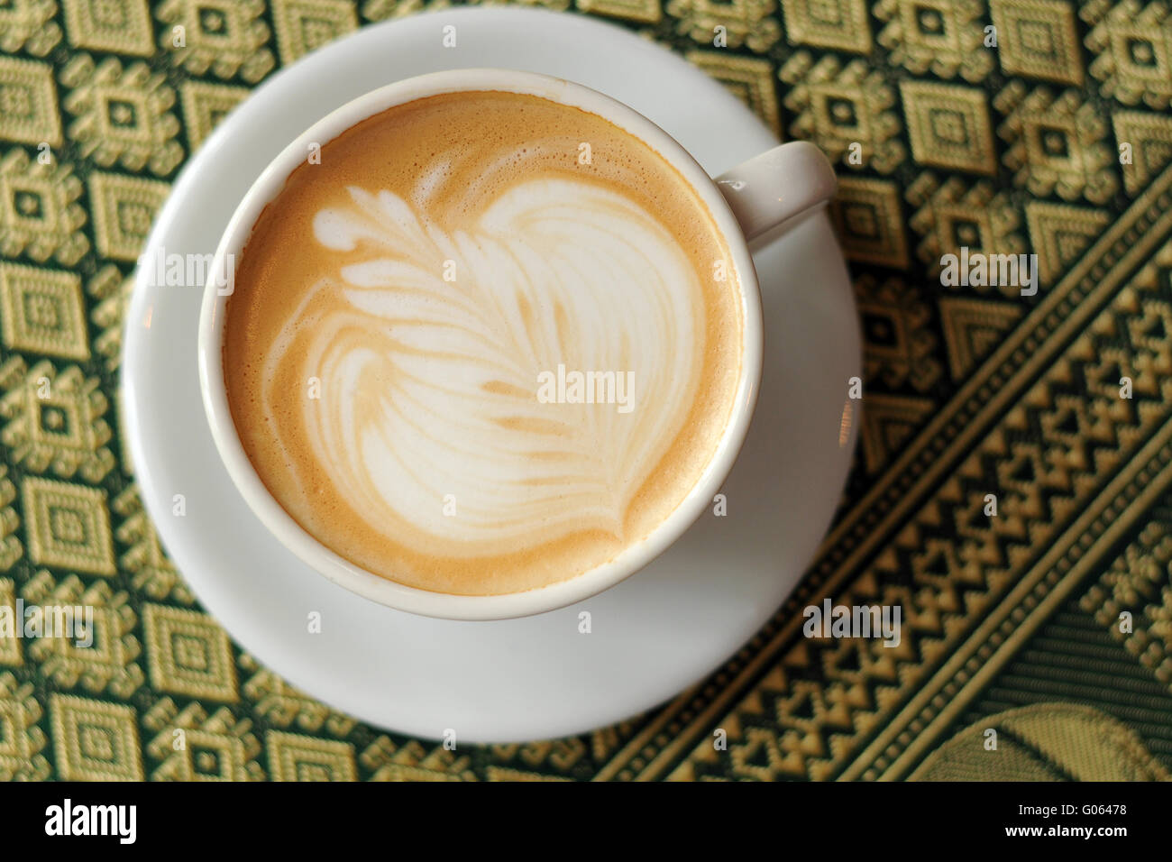 Cappuccino and latte art in white cup Stock Photo