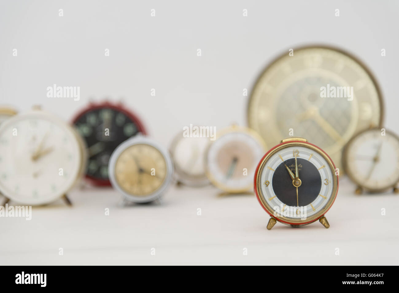 Old clocks showing different times Stock Photo Alamy