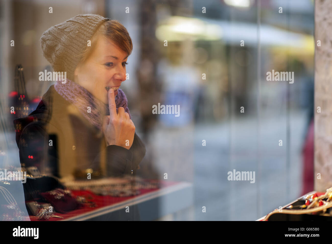 young woman looks at the window of a jewelery shop Stock Photo