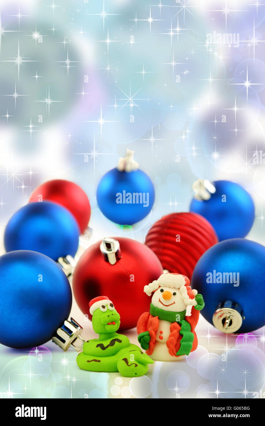 Christmas card with snake and cheerful snowman. Stock Photo