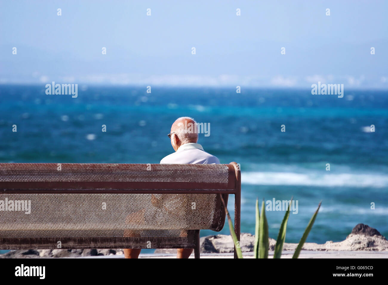 Old man looks at the sea Stock Photo