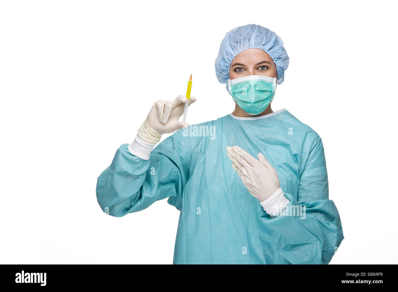 Doctor with surgical clothes and syringe in hand Stock Photo