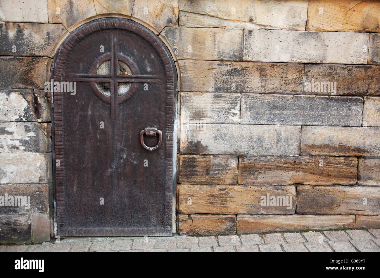Sturdy Old Door made of Metal on historic building Stock Photo