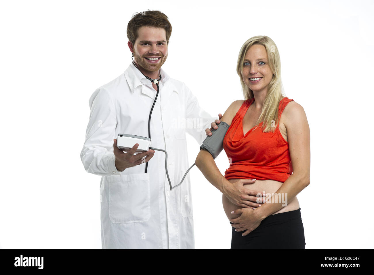 Doctor measures the blood pressure of a pregnant w Stock Photo