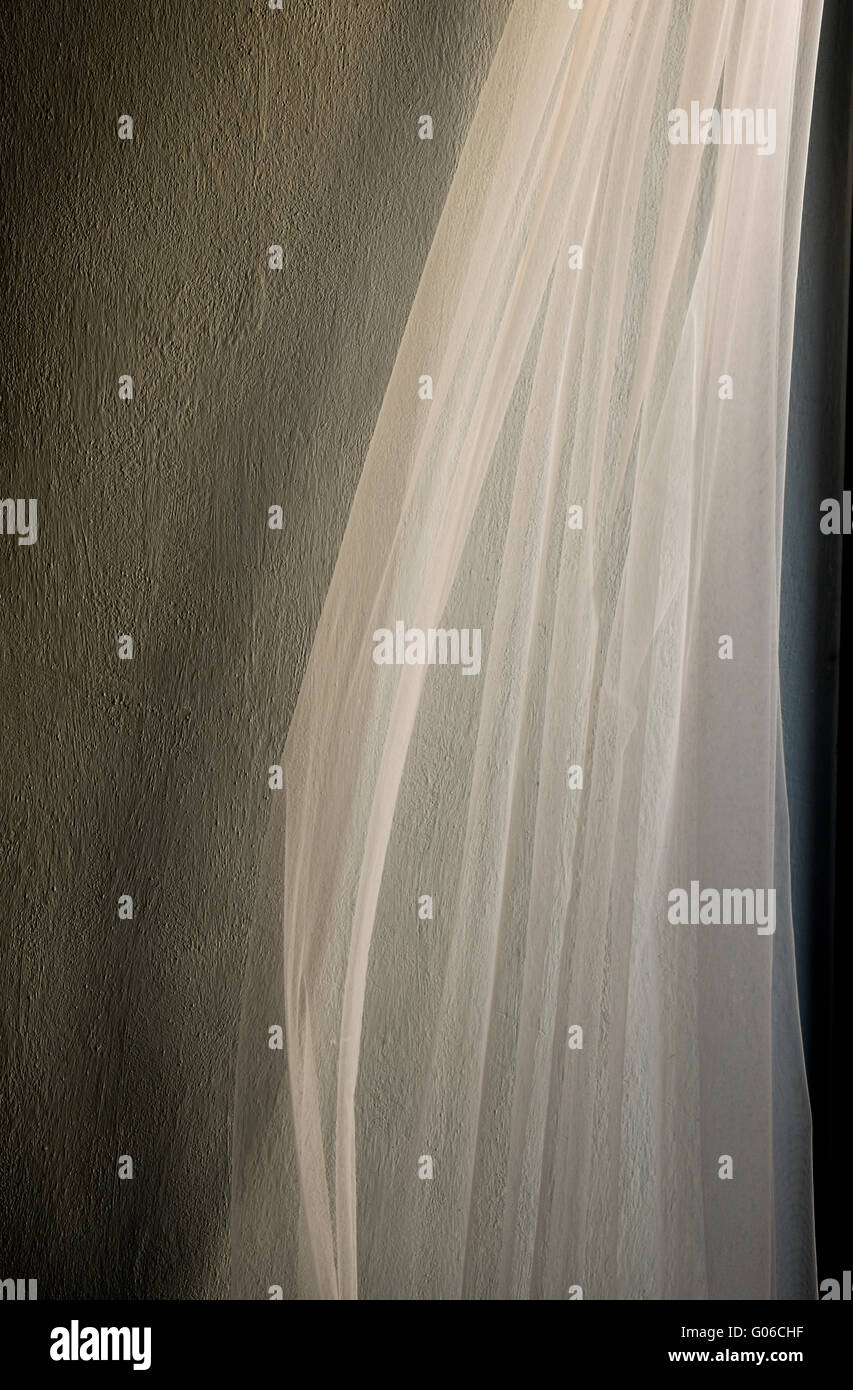 Sheer white curtains blowing in wind. Stock Photo