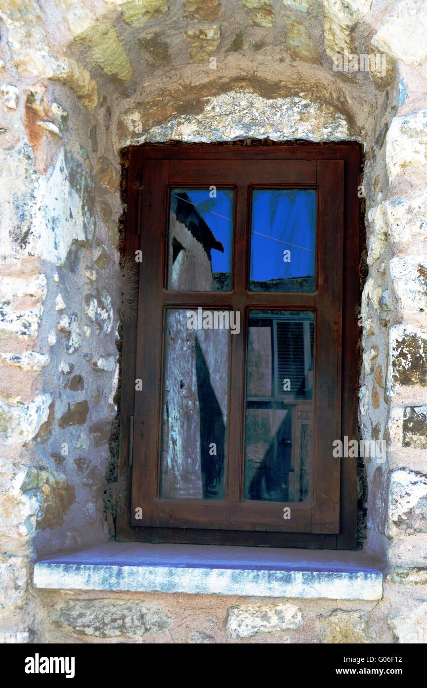 A wooden window on a wall of grey stones Stock Photo - Alamy